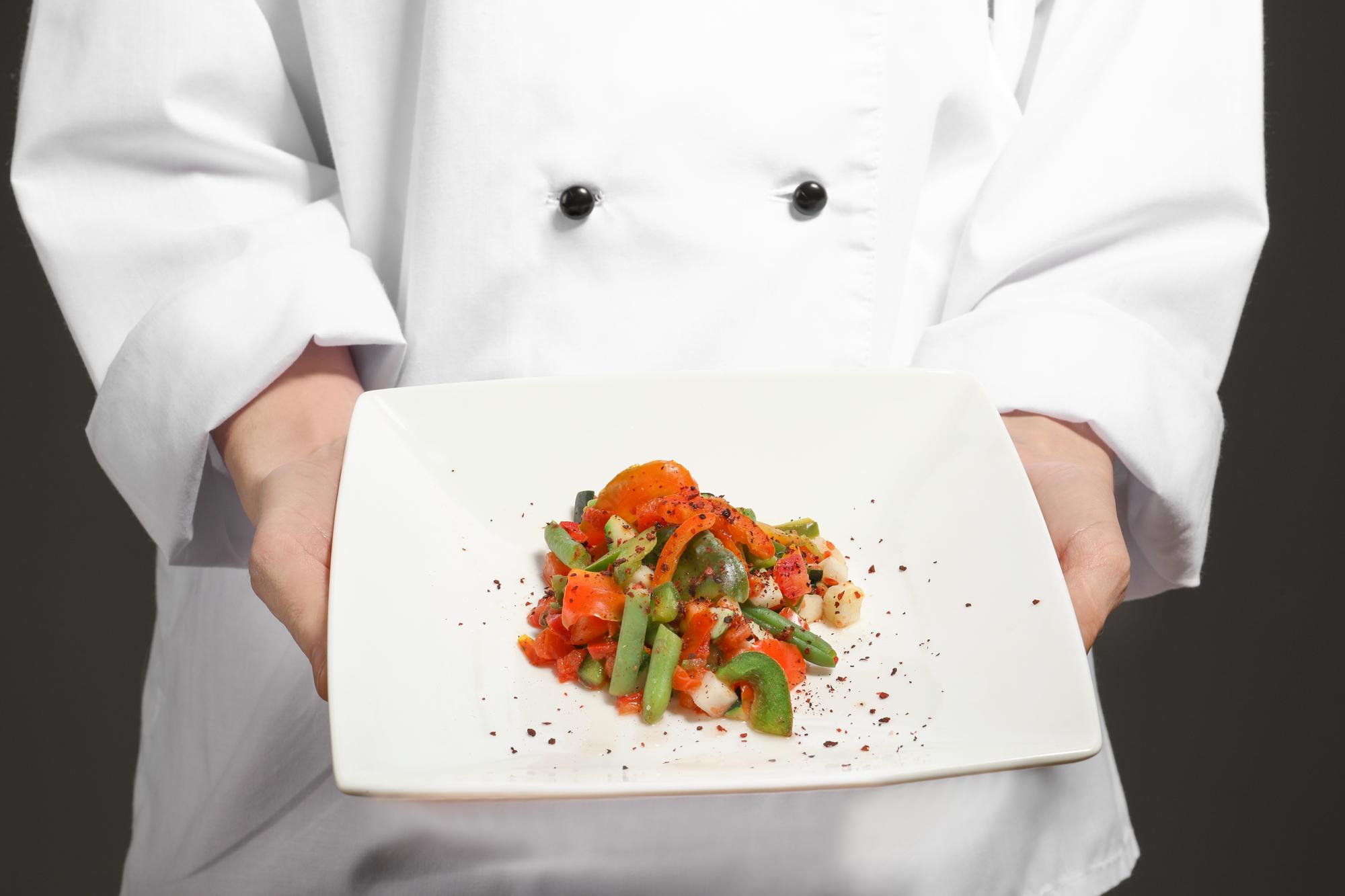 Chef demonstrates plating during an online class